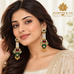 Model wearing long gold-plated red and green Kashmiri earrings