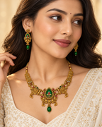 Model wearing gold-plated oval green stone necklace set with matching earrings