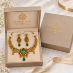 Gold-plated oval green stone necklace set in Jasmine & Co. packaging box