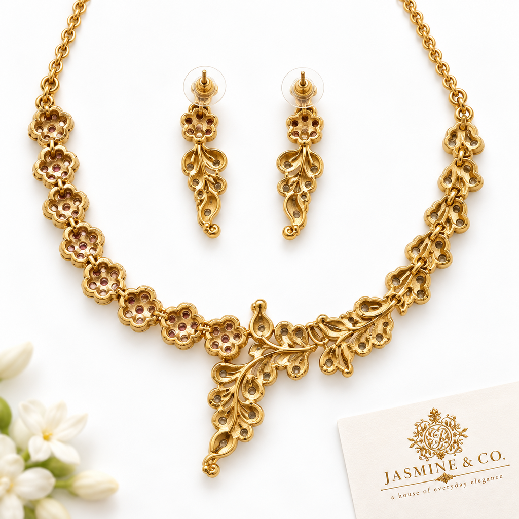 Back side view of fine stone gold-plated floral and leaf necklace set with matching earrings