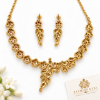 Back side view of fine stone gold-plated floral and leaf necklace set with matching earrings