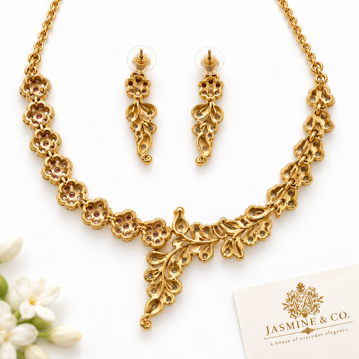 Back side view of fine stone gold-plated floral and leaf necklace set with matching earrings