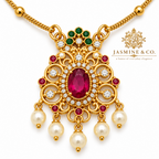 Close-up detail of gold-plated red stone pendant necklace