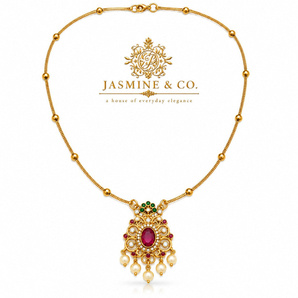 Red stone gold-plated pendant necklace included in Jasmine & Co. gift pack for Sister