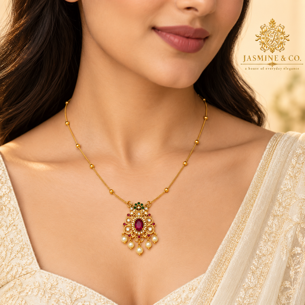 Model wearing gold-plated red stone pendant necklace