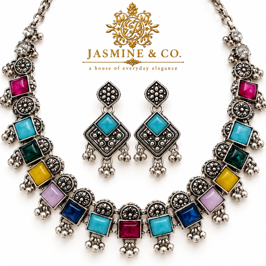 Close-up detailing of oxidized silver multicolor necklace with turquoise stone earrings