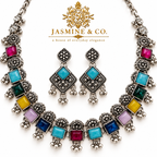 Close-up detailing of oxidized silver multicolor necklace with turquoise stone earrings