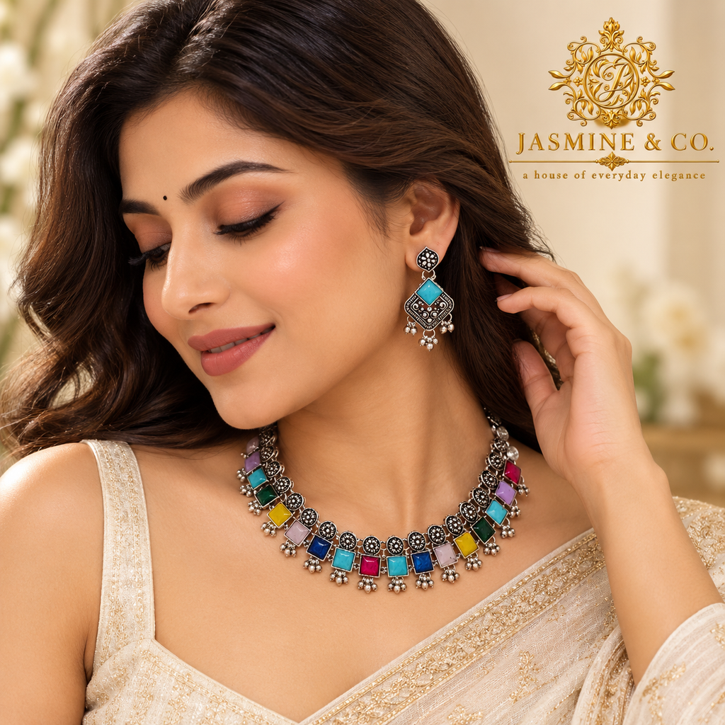 Model wearing oxidized silver multicolor necklace with matching blue earrings