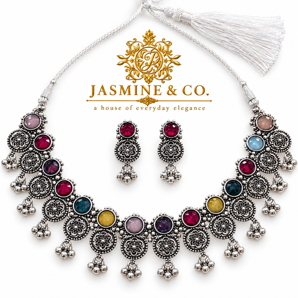 Studio hero image of multicolor oxidized silver-tone necklace set with red stone earrings