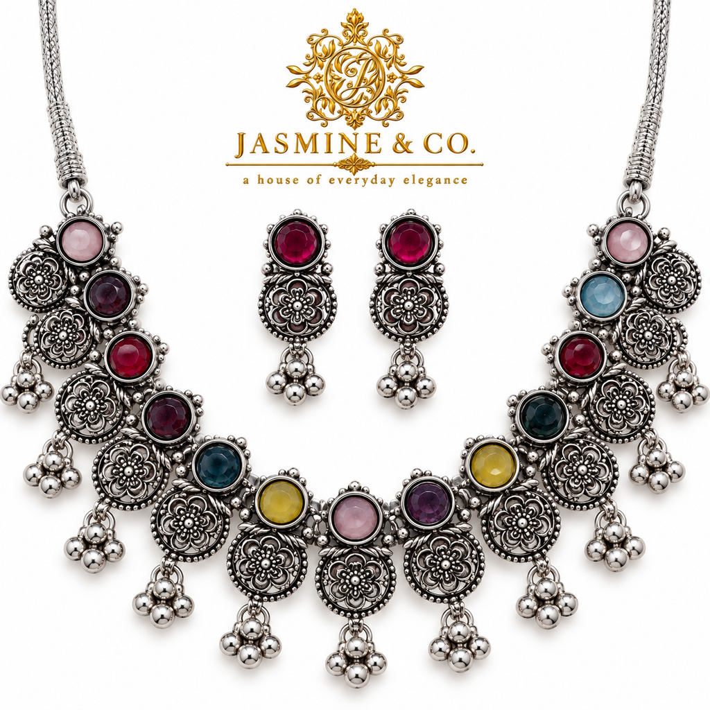 Close-up image showing silver floral motifs and multicolor round stones
