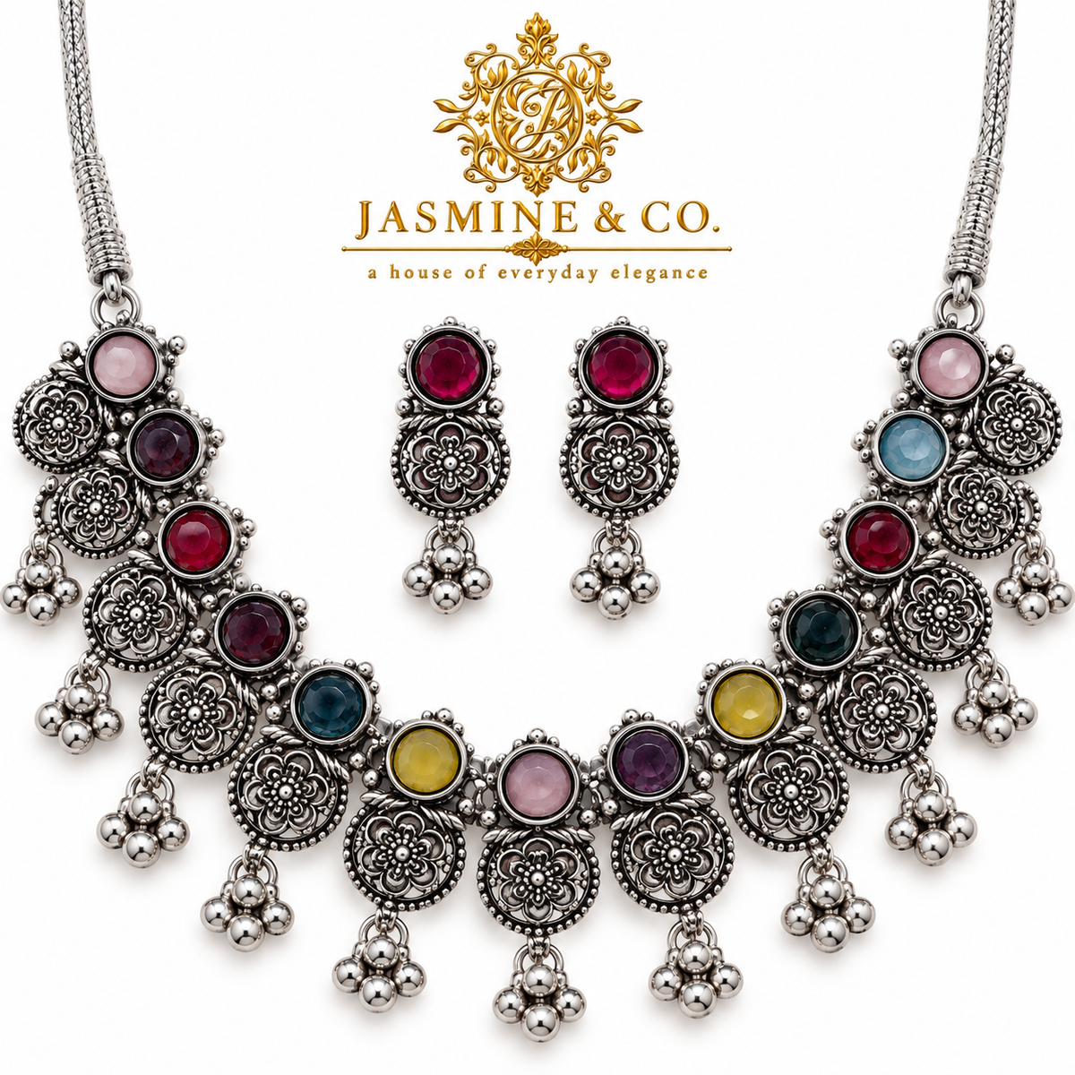 Close-up image showing silver floral motifs and multicolor round stones