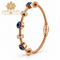Jasmine & Co. Gold-Plated Anti-Tarnish Evil Eye Cable Bangle Bracelet with Crystal Accents – front angled view