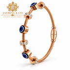 Jasmine & Co. Gold-Plated Anti-Tarnish Evil Eye Cable Bangle Bracelet with Crystal Accents – front angled view